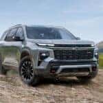 A grey 2025 Chevy Traverse parked off-road and angled right.