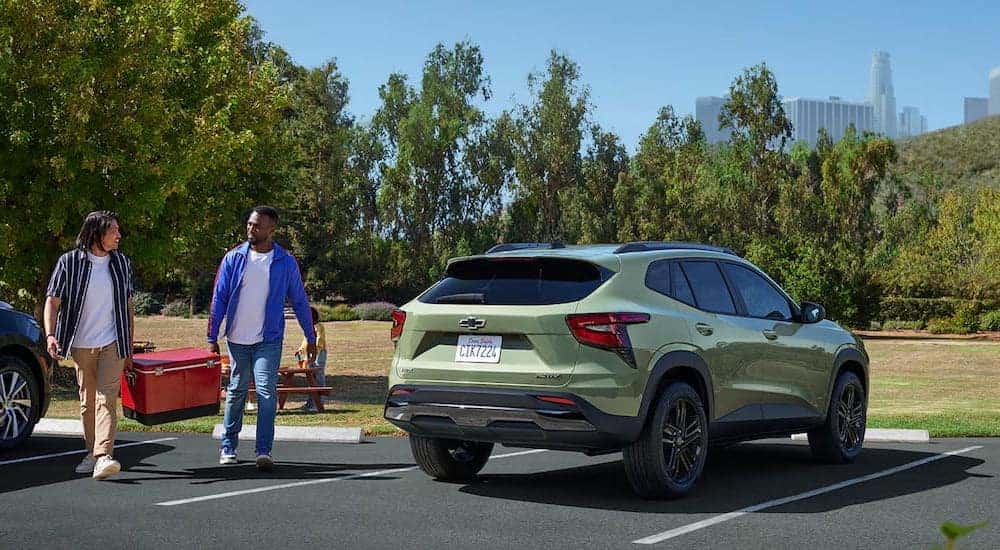 Rear view of a green 2025 Chevy Trax ACTIV parked on a parking lot.