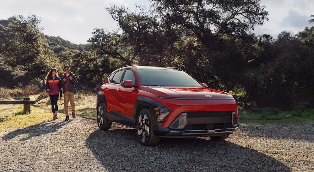 A red 2025 Hyundai Kona driving down off-road.