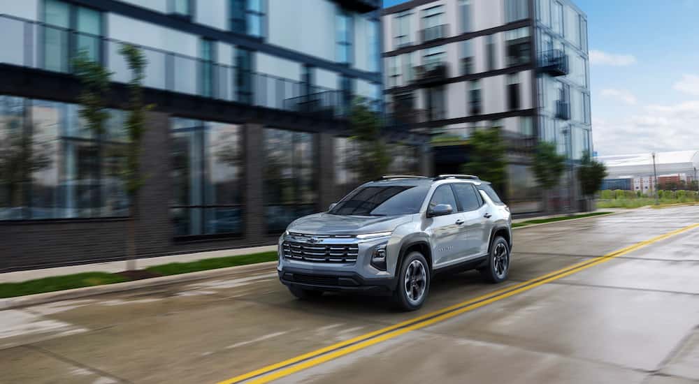 A grey 2025 Chevy Equinox is shown from the front at an angle during a 2025 Chevy Equinox vs 2025 Mitsubishi Eclipse Cross comparison.