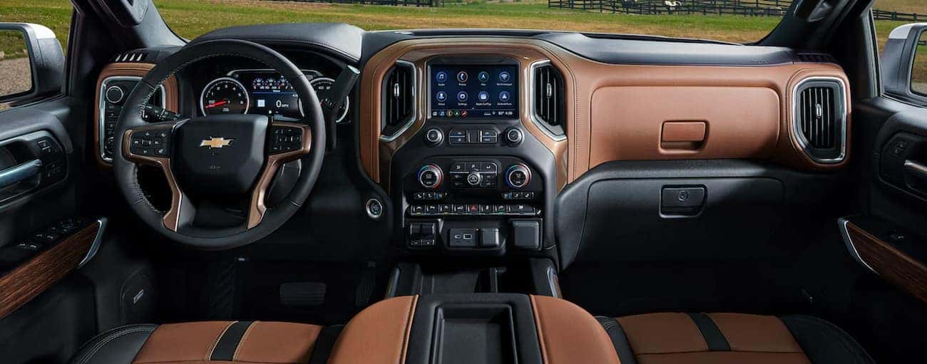 The brown and black interior and dash are shown in a 2021 Chevy Silverado 1500.