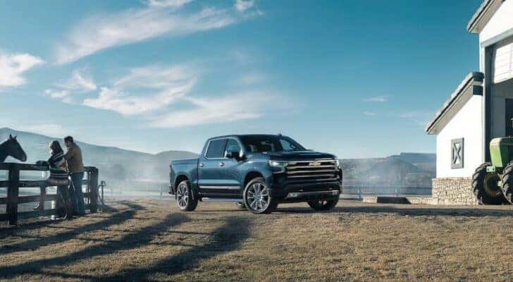 A black 2023 Chevy Silverado 1500 LT is shown parked on a ranch after viewing a used Chevy Silverado 1500 for sale in Albany.