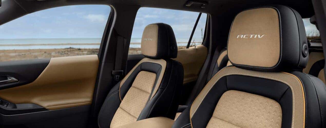 The black and tan front seats in a 2025 Chevy Equinox ACTIV.