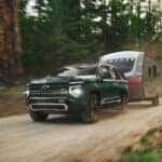 A green 2025 Chevy Tahoe Z71 is shown from the front at an angle.