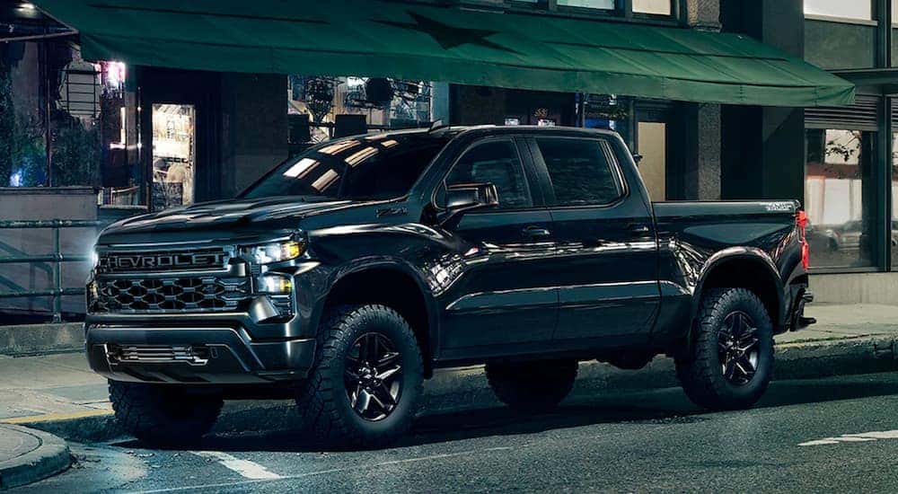 A black 2023 Chevy Silverado 1500 Trail Boss is shown from the front at an angle.