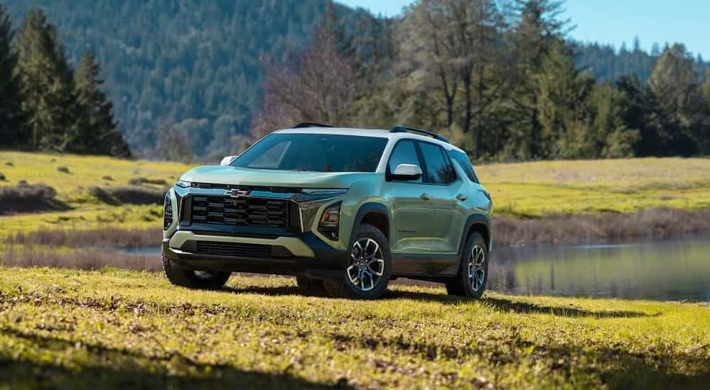 A green 2025 Chevy Equinox ACTIV parked off-road.
