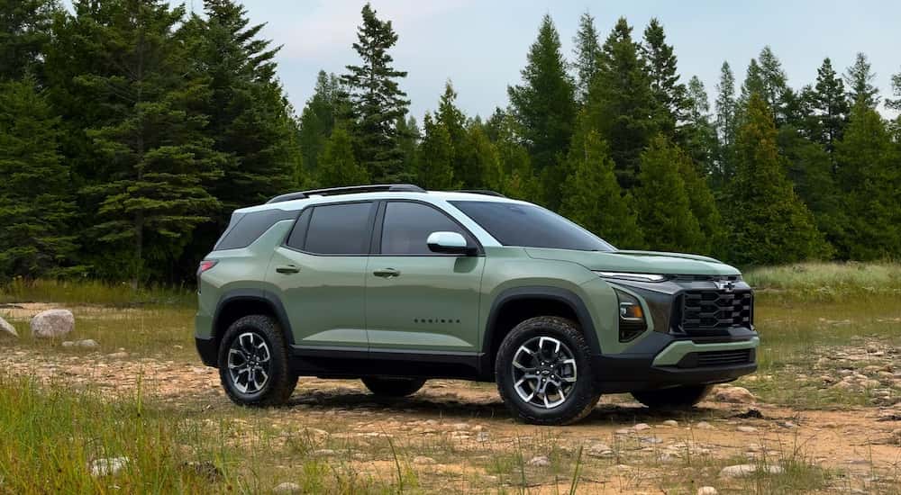 A green 2025 Chevy Equinox parked on a field.