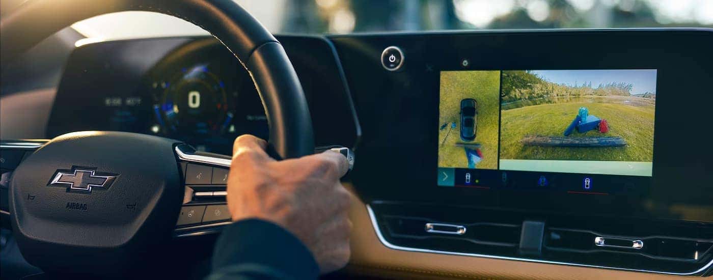 Man using the backup camera in a 2025 Chevy Equinox.