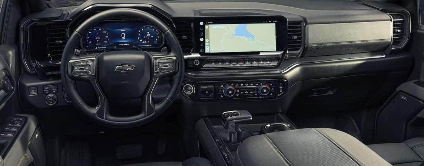 The black interior and dash are shown in a 2025 Chevy Silverado 1500.