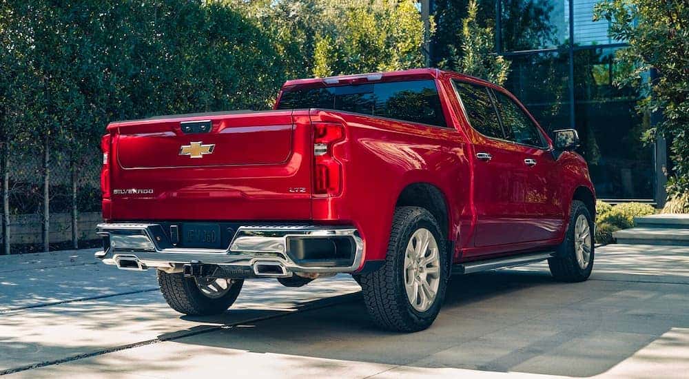 Rear view of a red 2025 Chevy Silverado 1500 LTZ parked on a driveway.