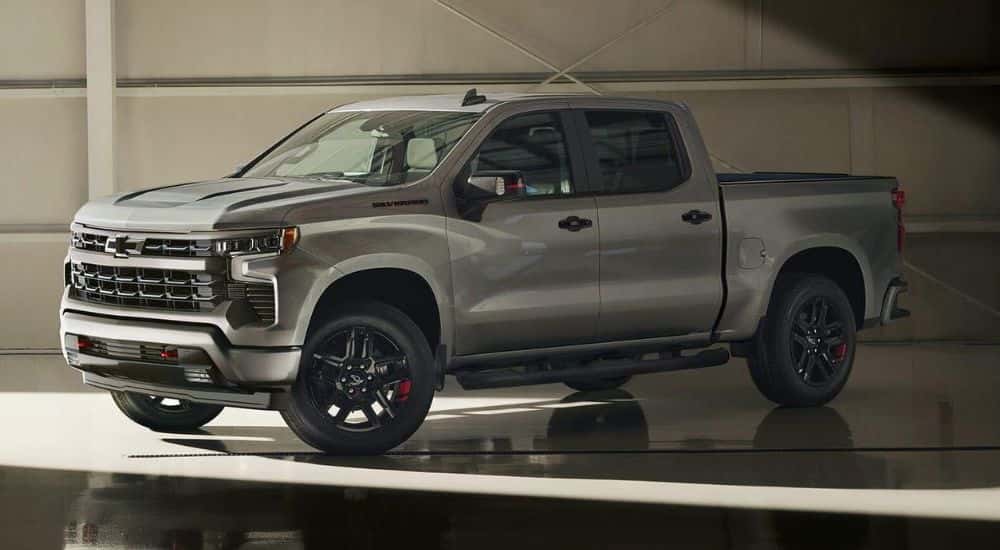 A grey 2024 Chevy Silverado 1500 Redline parked in a showroom.