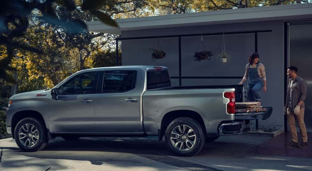 A silver 2025 Chevy Silverado 1500 Z71 parked near a house.