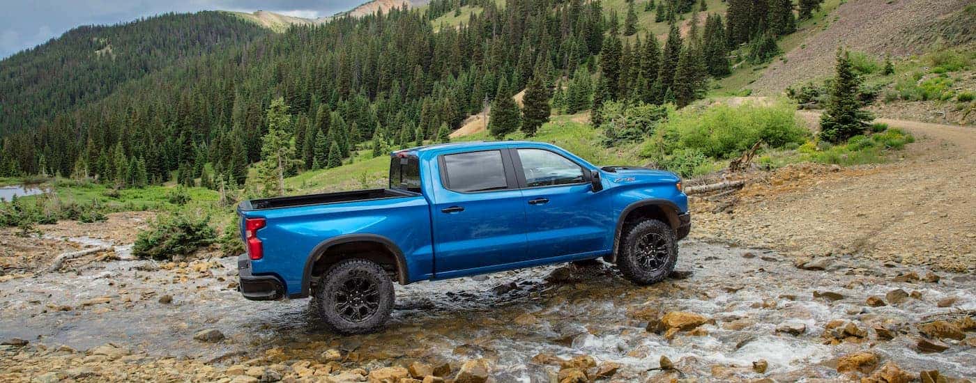 A blue 2025 Chevy Silverado 1500 ZR2 is shown from the side.