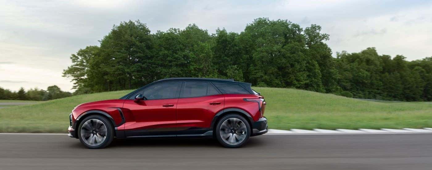 A red 2025 Chevy Blazer EV driving on a racetrack.