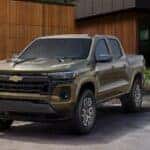 A green 2025 Chevy Colorado Z71 parked near a house.