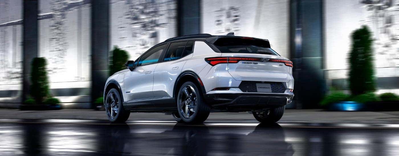 A white 2025 Chevy Equinox EV RS on wet pavement.