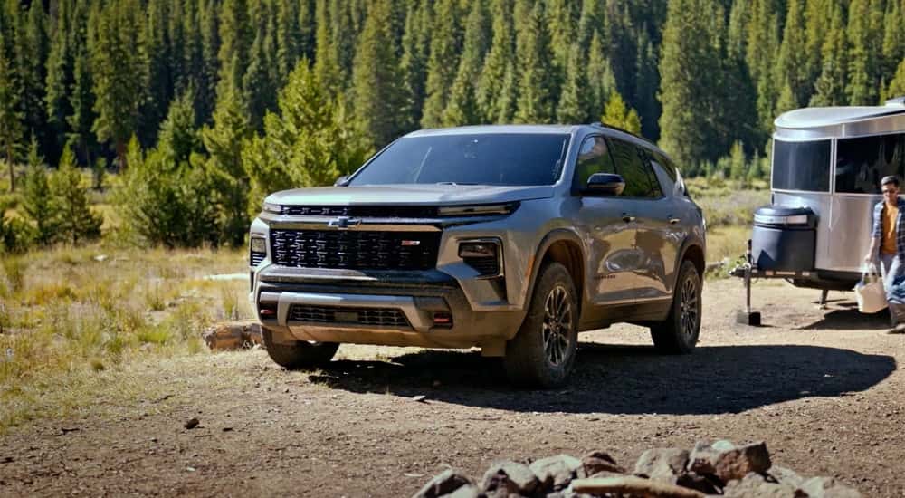 A grey 2025 Chevy Traverse Z71 parked at a campsite.