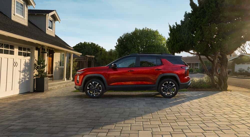 A red 2026 Chevy Equinox parked in a driveway