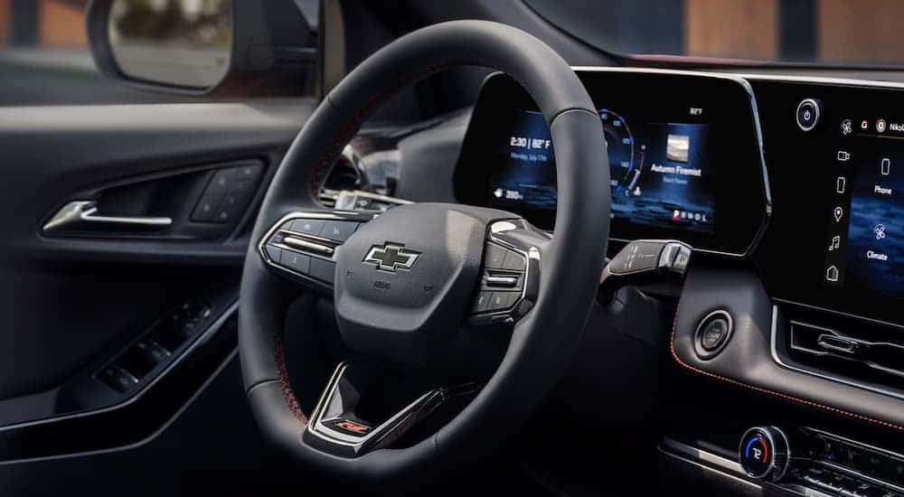 The steering wheel and digital gauge cluster on a 2026 Chevy Equinox