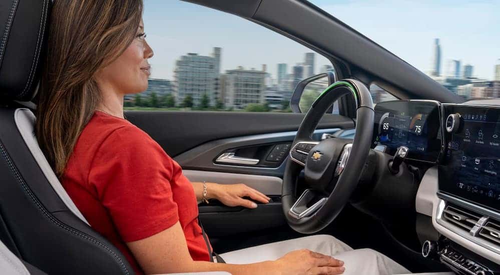 A person driving in a 2025 Chevy Equinox EV.