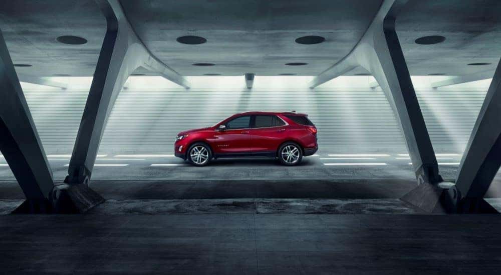 Red 2018 Chevy Equinox driving in a tunnel.