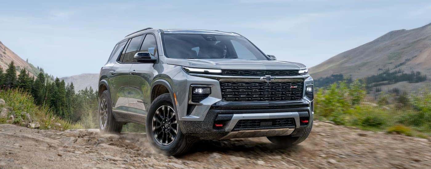 A gray 2025 Chevy Traverse driving off-road