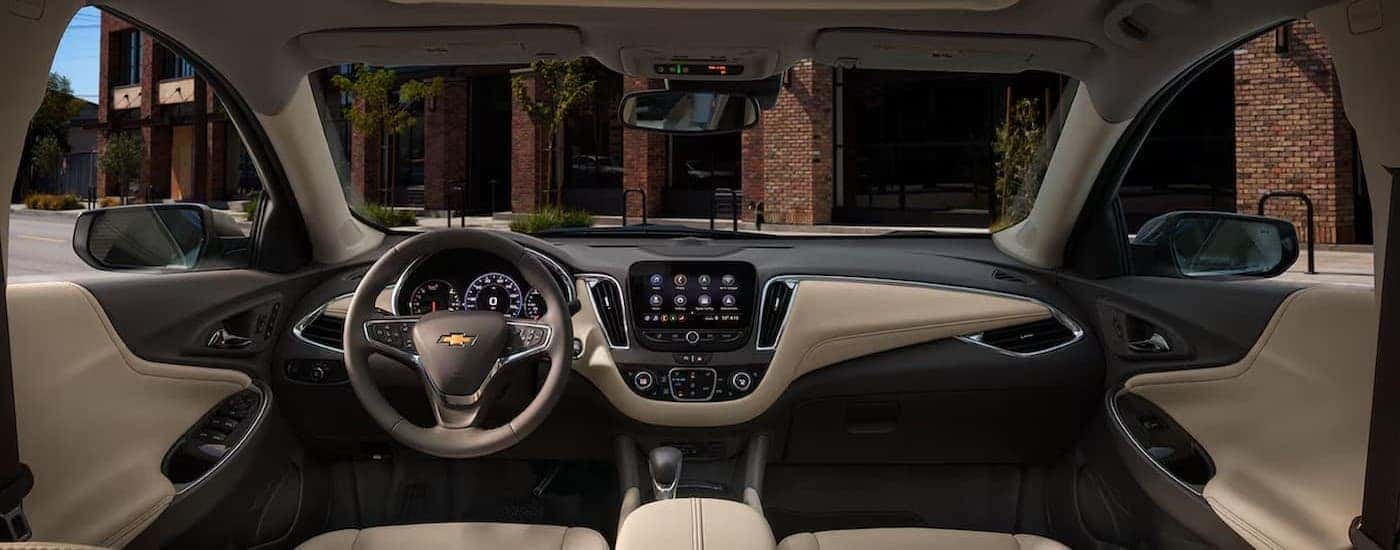 The black and tan interior and dash in a 2025 Chevy Malibu for sale near Latham.