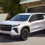 A white 2025 Chevy Trverse High Country parked on a driveway.