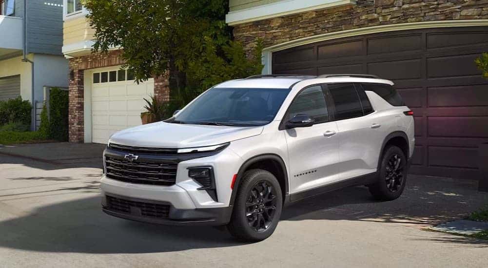 A white 2025 Chevy Trverse High Country parked on a driveway.