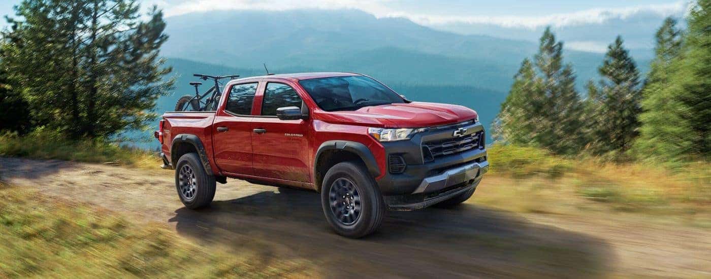 A red 2025 Chevy Colorado driving on a trail