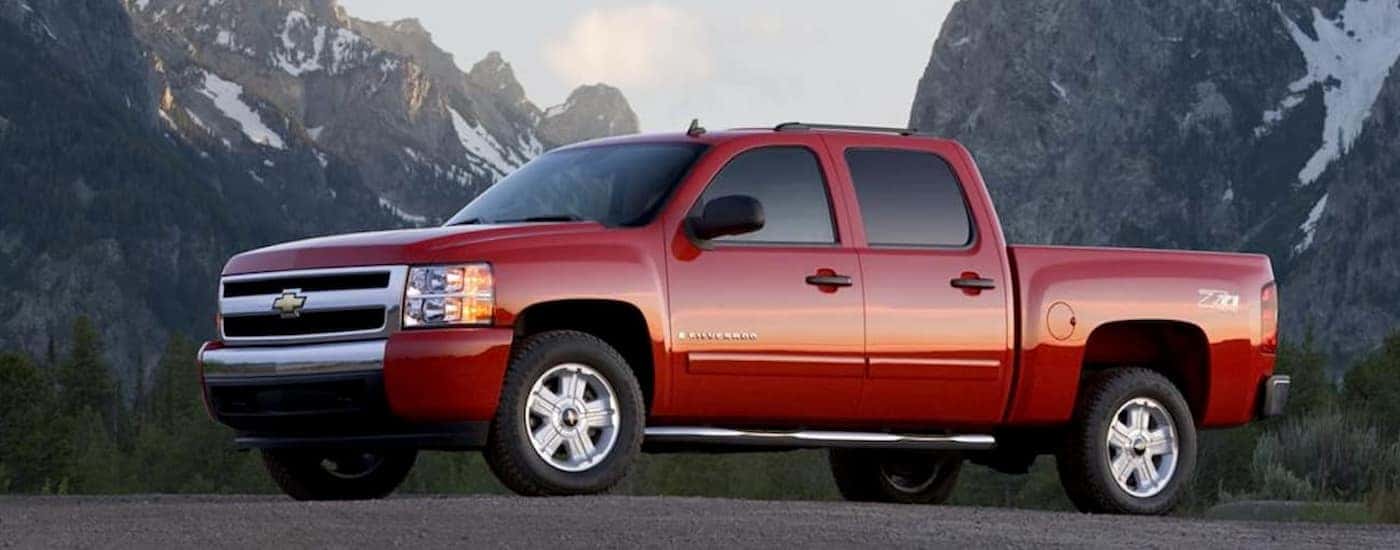 A red 2011 Chevy Silverado 1500 Z71 parked near mountains.
