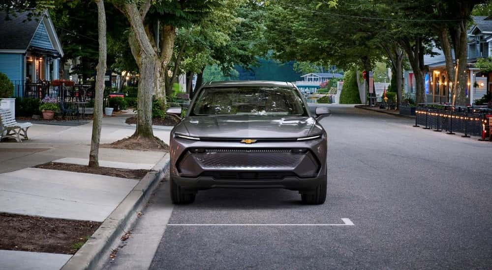 A silver 2025 Chevy Equinox EV 1LT parked in a city