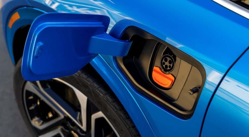 Charging port on a blue 2025 Chevy Equinox EV for sale in Albany