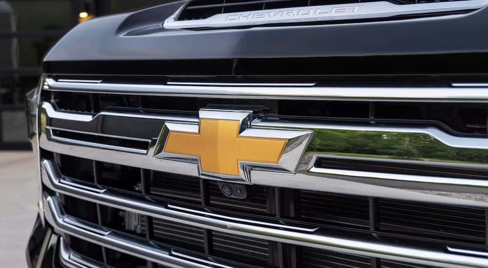 Close-up of the grille on a black 2025 Chevy Silverado 3500 HD