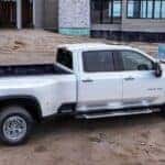 A white 2025 Chevy Silverado 3500 HD parked at a construction site