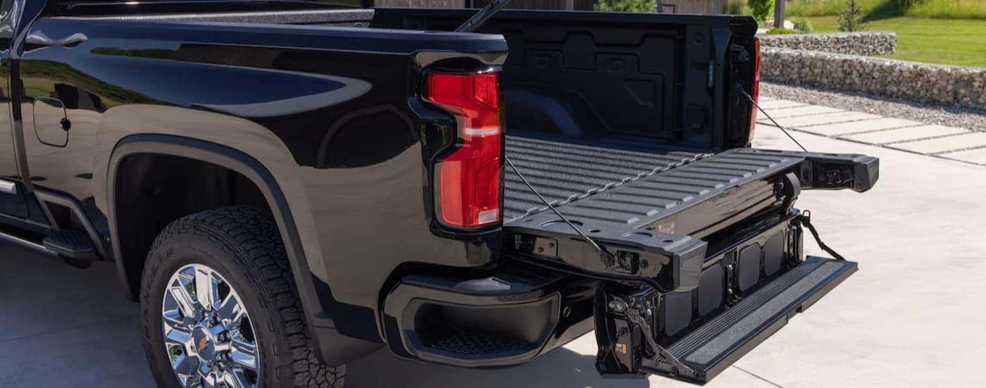 An open tailgate on a black 2025 Chevy Silverado 3500 HD.