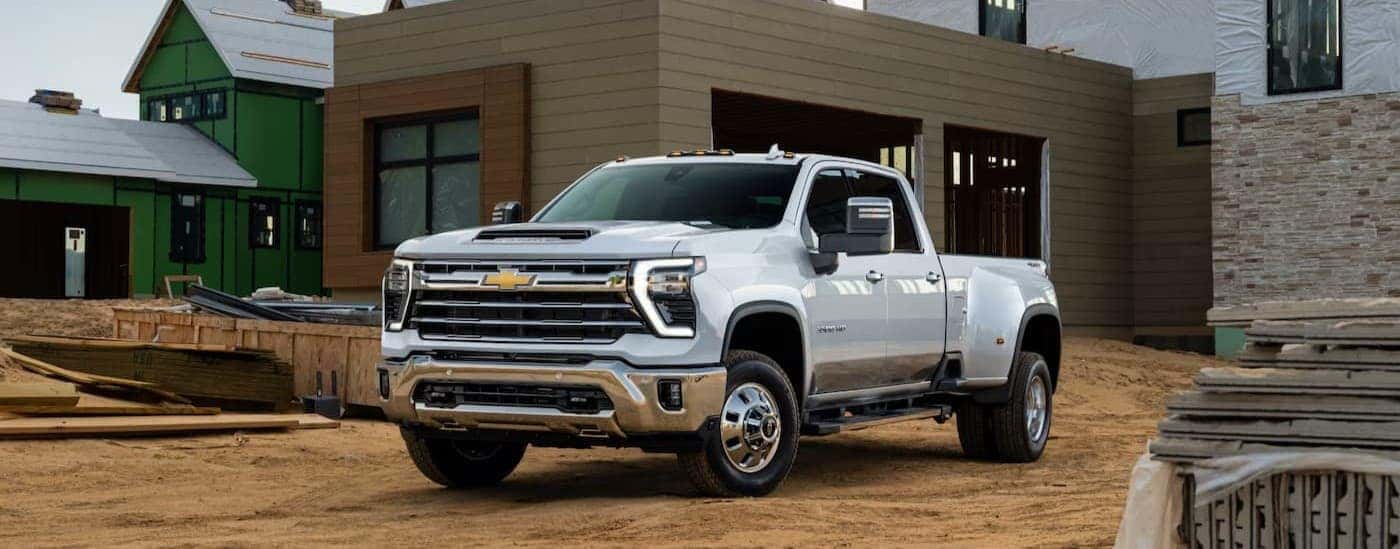 A white 2025 Chevy Silverado 3500 HD parked on a construction site.