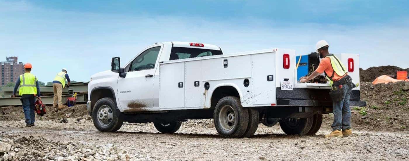 A white 2025 Chevy Silverado 3500 HD parked on a construction site.