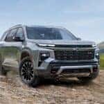 A silver 2025 Chevy Traverse driving off-road