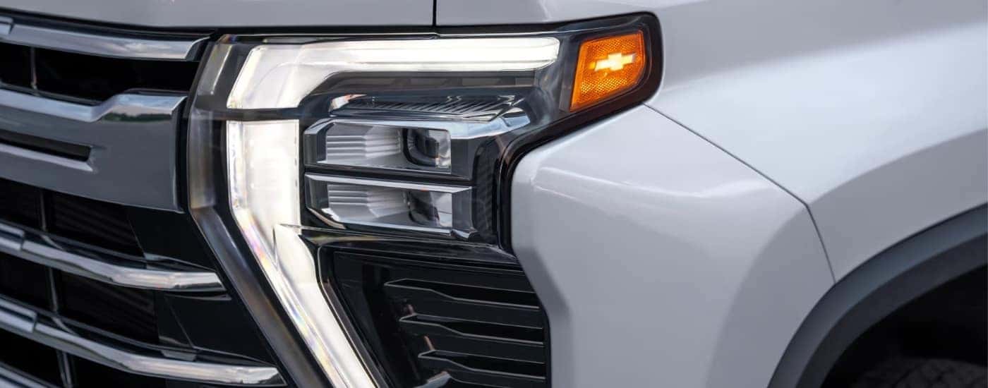 Driver side headlight on a white 2025 Chevy Silverado 2500 HD