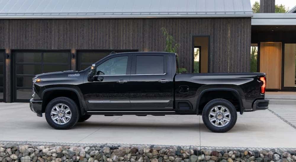 A black 2025 Chevy Silverado 2500 High Country parked on a driveway.