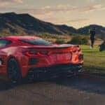 People golfing near a 2026 Chevy Corvette.