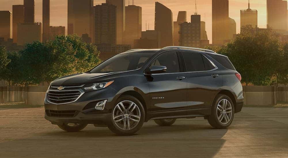 A black 2020 Chevy Equinox parked in a city.