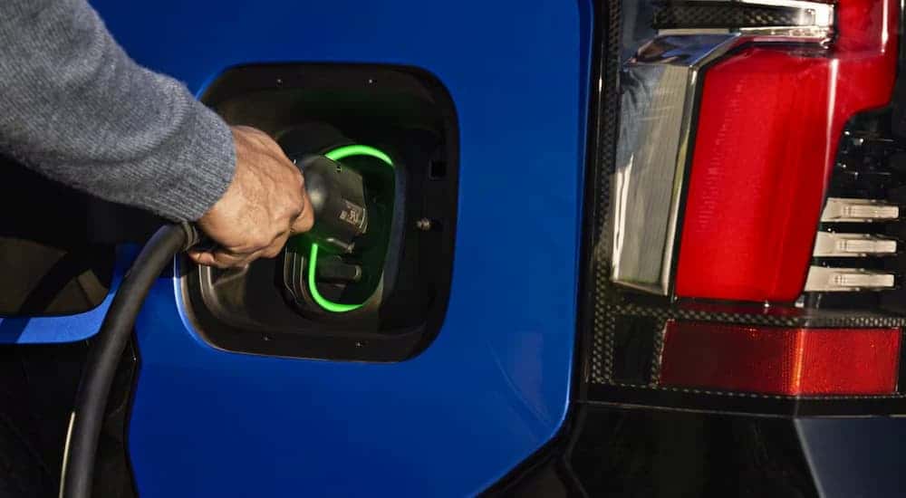 A charging port on a 2025 Chevy Silverado EV vs 2025 Rivian R1T