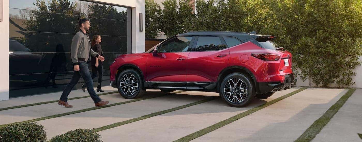 A red 2025 Chevy Blazer parked on a driveway.