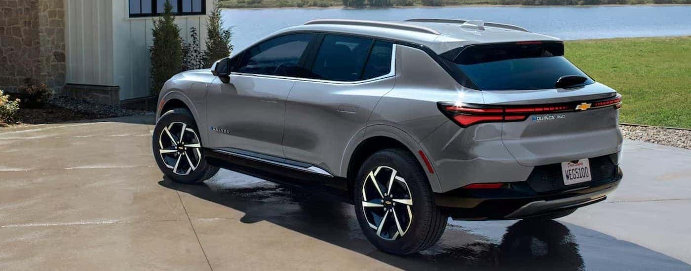 A silver 2024 Chevy Equinox EV parked on a driveway.