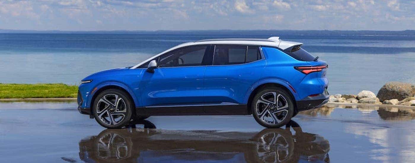 A blue 2025 Chevy Equinox EV from the side.