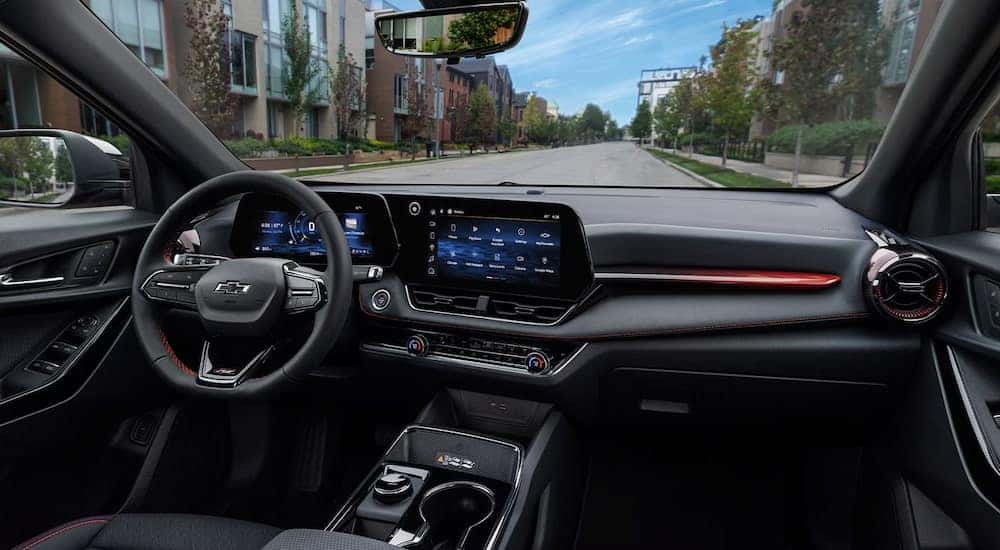Black interior, digital gauge cluster, and infotainment system on a 2026 Chevy Equinox.