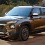 Brown 2021 Chevy Trailblazer driving to a used car dealership.