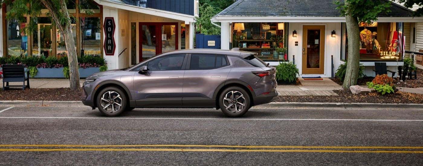 A gray 2024 Chevy Equinox EV 1LT parked outside a store